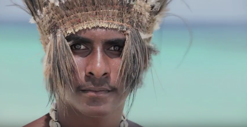Man wearing Torres Strait Islander traditional head dress.